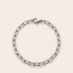 Silver elongated cable chain bracelet on bone