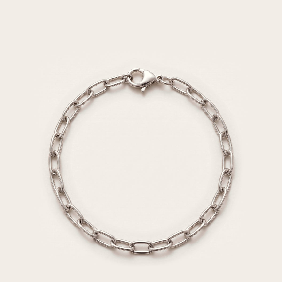Silver elongated cable chain bracelet on bone