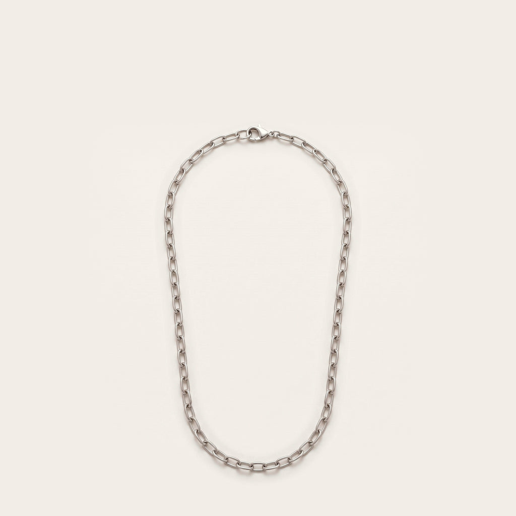 Silver elongated cable chain necklace on bone